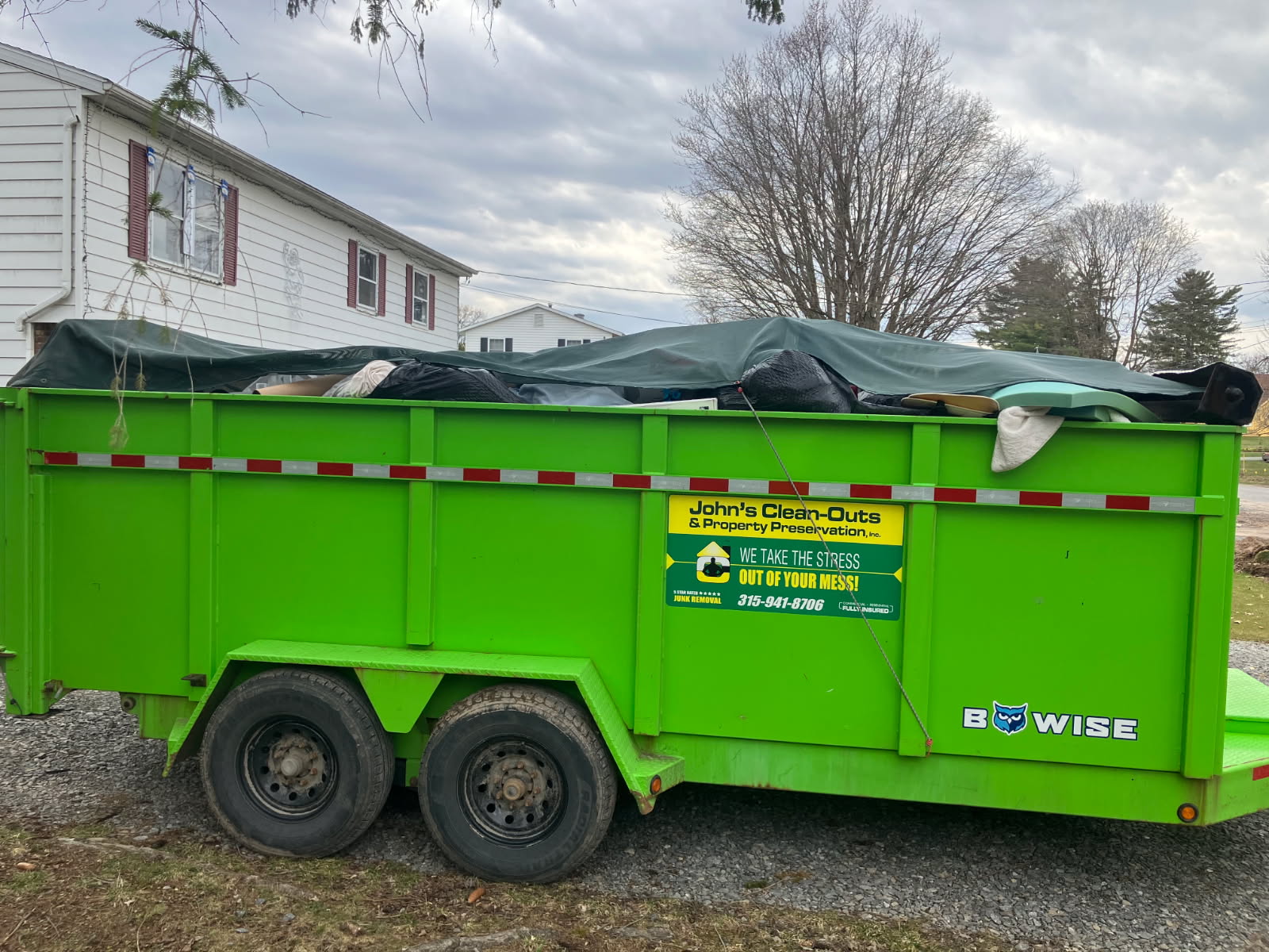 John's Clean-Outs branded trailer serving Utica NY junk removal